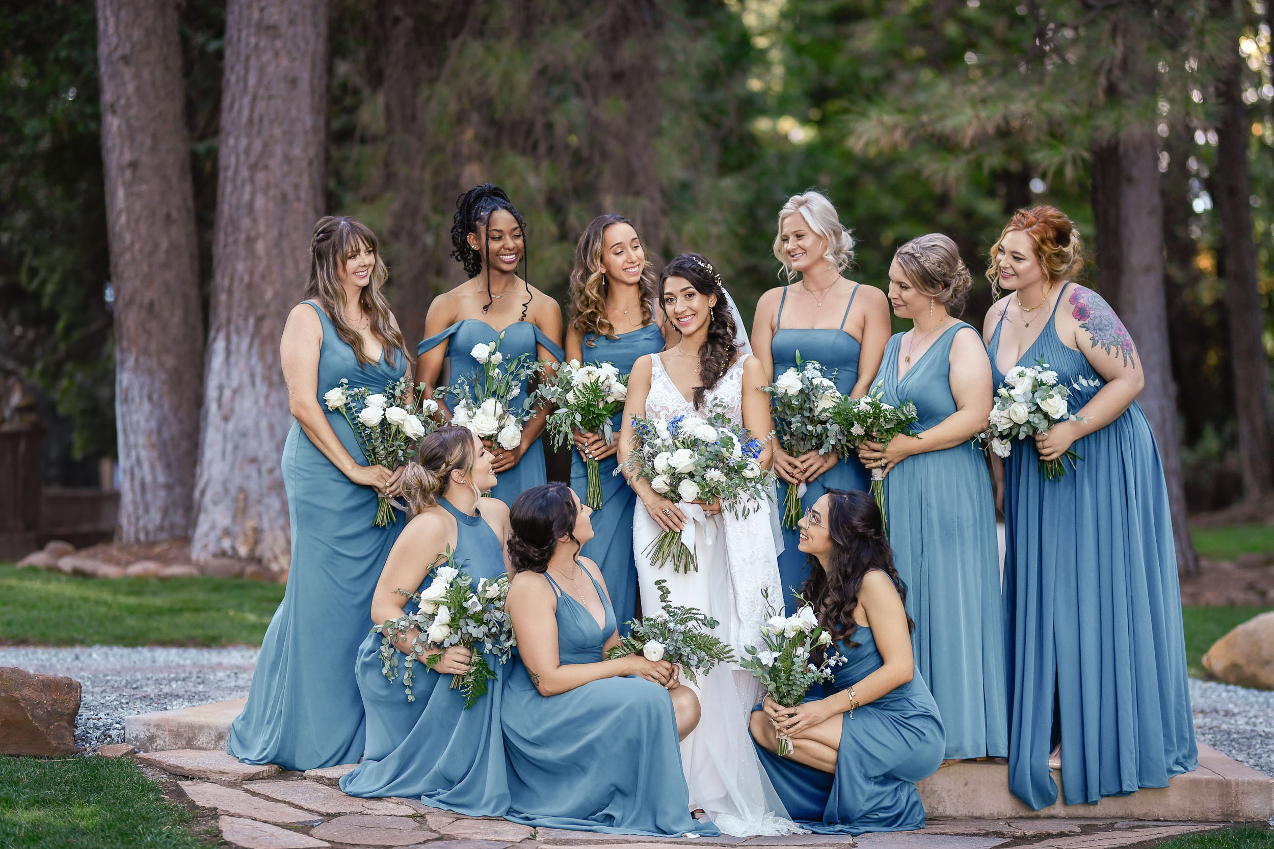 A group of bridesmaids in blue dresses pose for a photo.